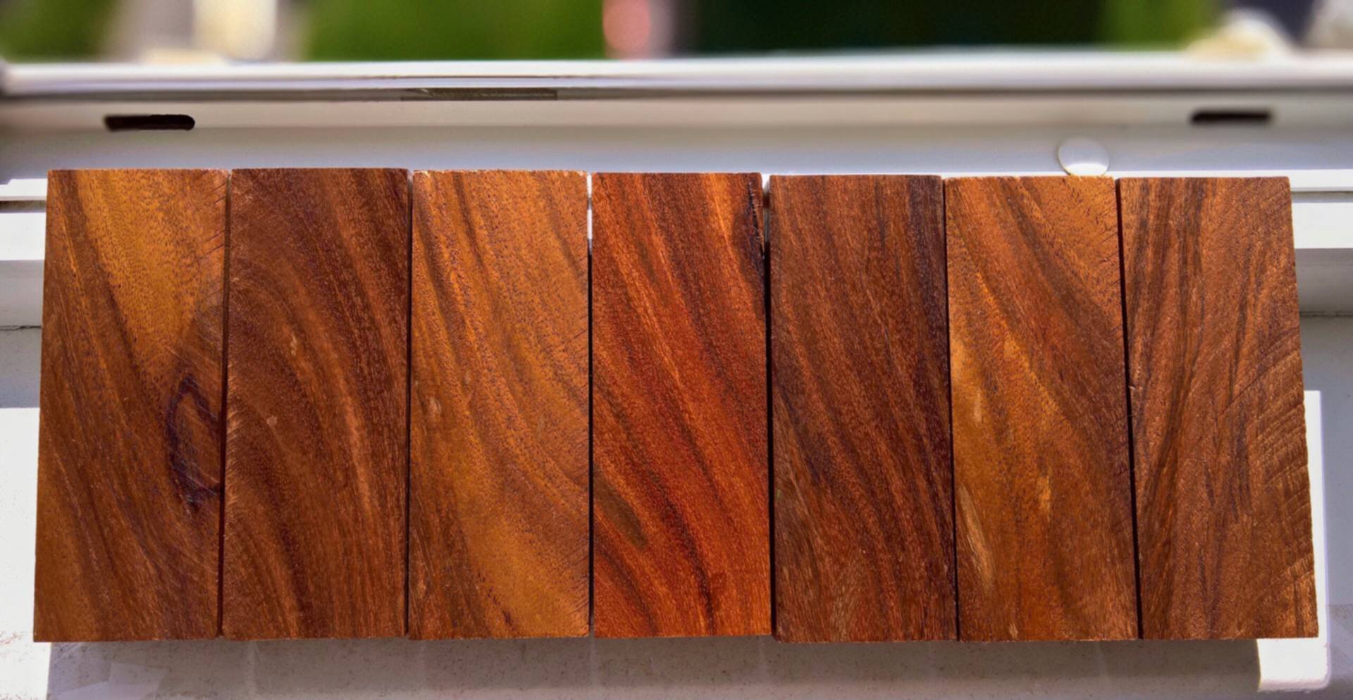 Polished aluminum knobs with ebony and cocobolo inlays